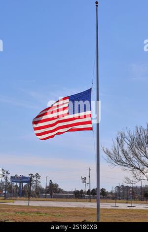 Die Flagge der Vereinigten Staaten, die mit Halbmaske vor dem Rathaus in Lakeland GA fliegt, zu Ehren des verstorbenen Präsidenten Jimmy Carter! (1924-2024, 100 Jahre) Stockfoto