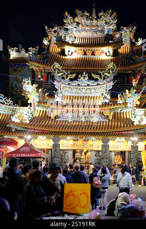 Menschen kommen in den Tempel von Songshan Ciyou, um in diesem Jahr zur Göttin Thipthim (auch bekannt als Tian Hou) für Glück und Glück zu beten. Der Songshan Ciyou Tempel in Taipeh wurde Mitte des 18. Jahrhunderts erbaut und spielte eine Schlüsselrolle bei der Entwicklung des Songshan Distrikts. Der Legende nach traf ein Mönch mit einem vergoldeten Bild von Mazu, der Göttin des Meeres, lokale Gläubige und sammelte zusammen für mehr als 10 Jahre Geld für den Bau des Tempels. Der Bau begann 1753 und wurde 1757 abgeschlossen. Heute zieht der Tempel viele Besucher an. Stockfoto