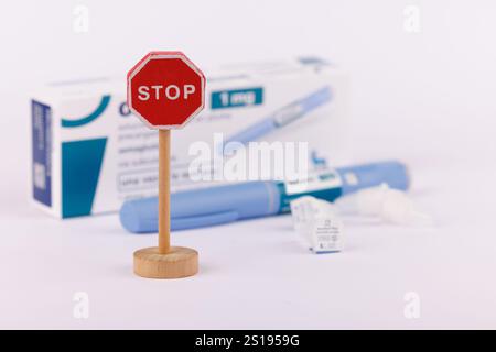 Anzeige des Toy Stop Sign mit Ozempic 1 ml Medikation Box und Injektionsstiften auf hellweißem Hintergrund in Barcelona, Spanien Stockfoto