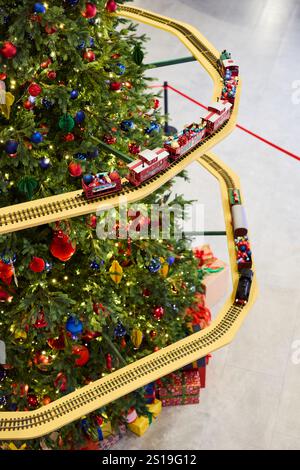 Ein wunderschöner festlicher Zug umrundet einen lebendigen Weihnachtsbaum Stockfoto