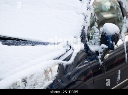 München, Deutschland. Januar 2025. Schnee liegt auf einem geparkten Auto am Straßenrand im Stadtzentrum. Quelle: Sven Hoppe/dpa/Alamy Live News Stockfoto