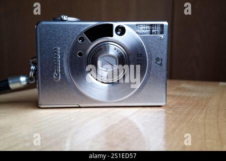 Canon IXUS II Kompaktkamera, auch bekannt als Canon ELPH 2 oder IXY 320 für APS Filmsystem, auf Holztisch. Salo, Finnland. Dezember 2024. Stockfoto