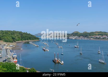 Conwy Wales - July 31 2024; View from Conwy castle over town and river with street below and city buildings with boats and Quay below. Stockfoto