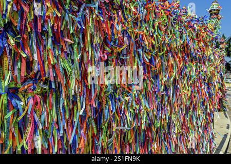 Bunte Bänder unseres Herrn von Bonfim, die an den Zäunen rund um die Kirche in Salvador, Bahia Salvador, Bahia, Brasilien, Südamerika gebunden sind Stockfoto