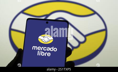 Mobiltelefon mit Logo des argentinischen E-Commerce-Unternehmens Mercado Libre Inc. Auf dem Bildschirm vor der Business-Website. Konzentrieren Sie sich auf die Mitte des Telefondisplays. Stockfoto