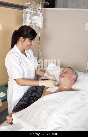 Eine Krankenschwester gibt einem Patienten eine Infusion Österreich Stockfoto