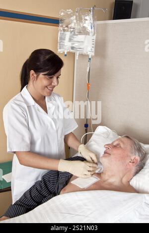 Eine Krankenschwester gibt einem Patienten eine Infusion Österreich Stockfoto