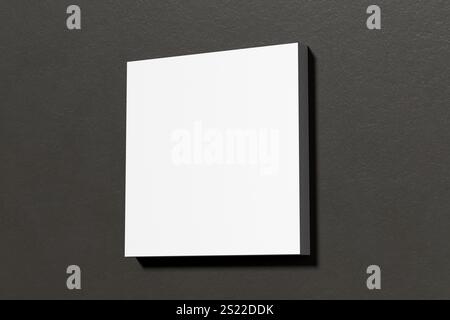 Minimalistische Komposition mit einer leeren weißen quadratischen Leinwand auf einer schwarzen Wand, ideal für die Präsentation von Kunstwerken oder Designs. 3D-Rendering. Stockfoto