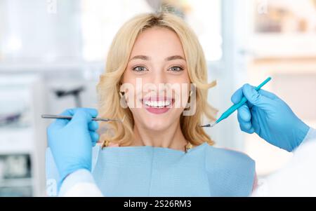 Nahaufnahme einer hübschen jungen Frau, die ihre weißen Zähne zeigt Stockfoto