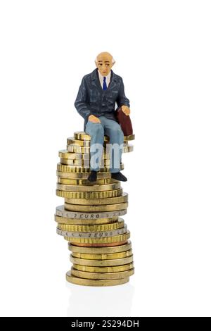 Rentner sitzt auf einem Haufen Geld, symbolisches Foto für Rente, Altersvorsorge, Alterssicherung Österreich Stockfoto