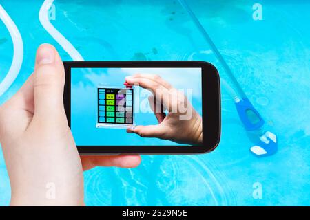 Travel Concept - touristische Fotografien einer Hand mit der pH-Indikator für den Säuregehalt des Wassers in einem Außenpool auf dem Smartphone Stockfoto