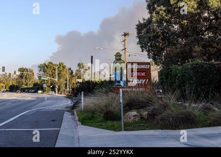 Malibu, Kalifornien, USA, 7. Januar 2025. Auf dem Schild „Smokey the Bear“ steht: „Feuer Gefahr extrem heute! Verhindern Sie Waldbrände, während das Palisades Feuer dunkle Rauch hinter dem Schild weht. Das Feuer brach am 7. Januar 2025 aus, wie vom PCH (Pacific Coast Highway) in der wohlhabenden Stadt Pacific Palisades am Rande von Malibu, CA, zu sehen war, weil die Santa Ana-Winde ungewöhnlich stark waren, die 100 KM/H überschritten hatten (Credit Image: © Amy Katz/ZUMA Press Wire). Nicht für kommerzielle ZWECKE! Stockfoto