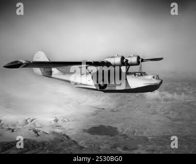 Ein konsolidiertes PBY Catalinain Amphibienflugboot im Flug. Catalinas diente bei allen Zweigen der US-Streitkräfte und bei den Luftstreitkräften und Marinen vieler anderer Nationen. Ursprünglich als Patrouillenbomber mit langer Einsatzreichweite konzipiert, wurde er auch in der U-Boot-Kriegsführung, bei Patrouillenbombardierungen, bei Konvoyeskorten, Such- und Rettungseinsätzen (insbesondere bei der Luft-See-Rettung) und bei Frachttransporten eingesetzt. Es war ein RAF Coastal Command Catalina, das von Nordirland aus flog, das 1941 das deutsche Schlachtschiff Bismarck lokalisierte, eine Sichtung, die schließlich zu seiner Zerstörung führte. Stockfoto