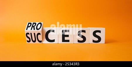 Symbol für Prozess und Erfolg. Cube mit Wörtern Success und Process wurde umgewandelt. Wunderschöner orangefarbener Hintergrund. Geschäftsmann Hand. Geschäftsprozesse und Prozesse und Erfolge Stockfoto