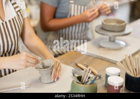 Zwei junge Frauen, die aus roher Lehm geformt wurden, sind unerkennbar Stockfoto