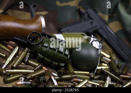 Verschiedene Arten von Munition und Granaten auf Tarngrund. Vorbereitung auf den Krieg. Besitz von Waffen. Verschiedene Arten von Munition auf einem Stockfoto