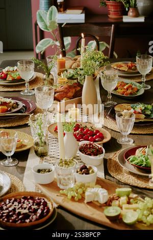 Vertikale Hochwinkelaufnahme festlicher leckerer Gerichte, Snacks und Desserts auf Holztisch im Speisesaal Stockfoto