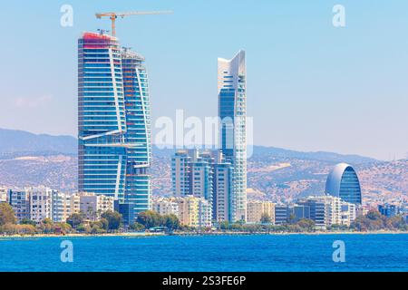 Die Skyline von Limassol auf Zypern mit modernen Hochhäusern entlang der Küste. Zu den markanten Bauten gehört ein gekrümmter Wolkenkratzer unter dem Bau Stockfoto