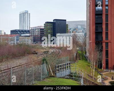 Salford , Manchester, Großbritannien, 01-04-2025: Middlewood Locks. Städtisches Stadtbild mit modernen Gebäuden und Bahngleisen im Vordergrund. Stockfoto