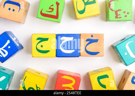 Holzblöcke mit arabischem Alphabet isoliert auf weißem Hintergrund. Würfel Mit Arabischem Alphabet. Vorschul- und Bildungskonzept. Kopierraum, flach Stockfoto