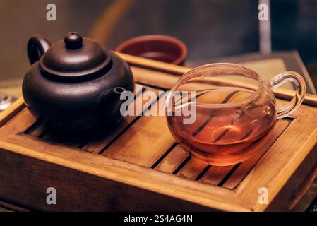 Duftender gesunder Tee in einem Glasbecher gebrüht in einer Teekanne, Café der indischen Küche Stockfoto