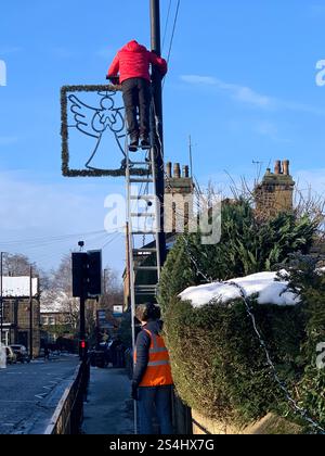 Burley in Wharfedale England Großbritannien Britisches England Yorkshire Großbritannien Schnee Eis Weihnachtsdorf Zentrum Geschäfte Straßenlaternen Straßenweg Pflaster alter Stein Stockfoto