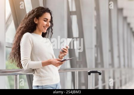 Porträt Der Schönen Jungen Frau Mit Smartphone Während Der Wartezeit Am Flughafen Stockfoto