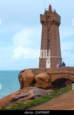 Leuchtturm Ploumanach (Leuchtturm Mean Ruz - erbaut 1946, geplant vom Architekten Henry Auffret) und Familie in der Nähe (Perros-Guirec, Bretagne, Frankreich). Stockfoto