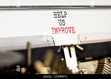 Helfen Sie uns, das Symbol zu verbessern. Konzeptworte helfen uns, die Schreibweise der schönen alten Retro-Vintage-Schreibmaschine zu verbessern. Schöner weißer Hintergrund. Geschäftliche Motivation Stockfoto