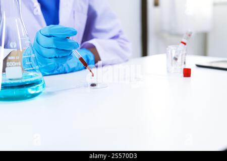 Wissenschaftler mit Coronavirus covid-19-infiziertem Blutprobenröhrchen. DNA-Testung des Blutes im Labor mit Blutentnahmeröhrchen und Stockfoto