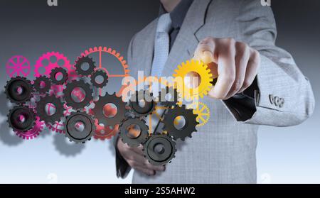Geschäftsmann Hand macht bunte Getriebe zum Erfolgskonzept Stockfoto