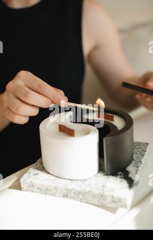 Nahaufnahme einer Frau, die eine Yin-Yang-Kerze anzündet Stockfoto