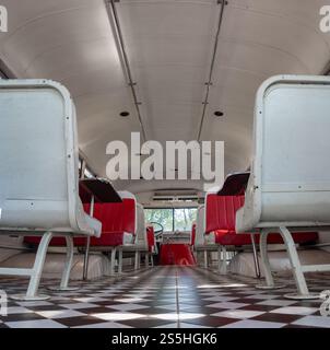 Innenraum eines alten Busses mit Bänken und Tischen Stockfoto