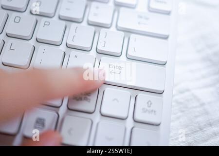 Hände einer Geschäftsfrau Zeigefinger drücken die Eingabetaste auf der Computertastatur Stockfoto