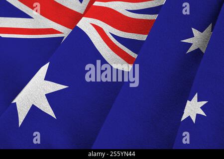Australien-Flagge mit großen Falten, die unter dem Studio-Licht in Innenräumen aus nächster Nähe winken. Die offiziellen Symbole und Farben im Stoffbanner. Australien Flagge mit Stockfoto