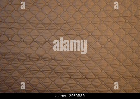 Gestrickter, strukturierter Hintergrund aus braunem braunem Stoff. Schöne olivbraune, zartblühende Textur. Gestrickter, strukturierter Hintergrund aus braunem braunem Stoff Stockfoto