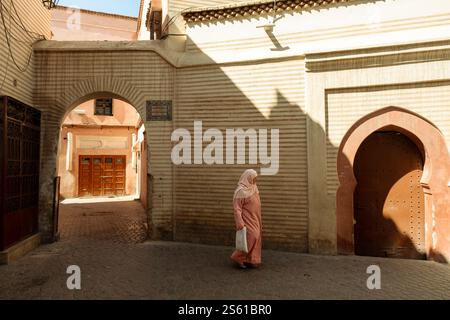 Frau mit Hijab, die durch die Straßen der Marrakesch Medina in Marokko läuft Stockfoto