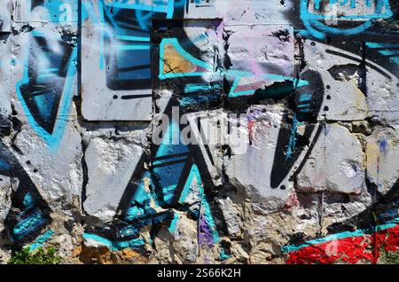 Fragment einer alten farbigen Graffiti-Zeichnung an der Wand. Hintergrundbild als Illustration von Street Art, Vandalismus und Wandmalerei mit Aerosol Stockfoto