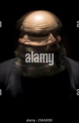 Ein Bild eines bewegungsunscharfen Porträts eines bärtigen kahlköpfigen Kopfmannes Stockfoto