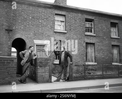 Arbeitende Männer Nachbarn reden außen terrassenförmig angelegten Häuser in Großbritannien 1962 1960s Stockfoto