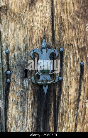 Nahaufnahme des antiken Türknaufs aus Schmiedeeisen an der Holztür Stockfoto