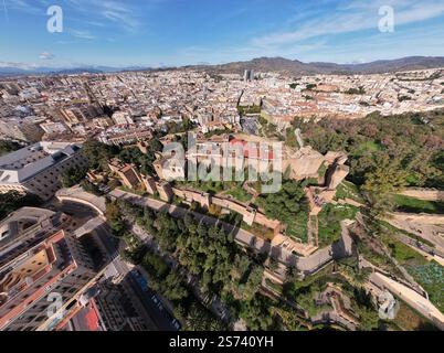 Super breiter Blick aus der Luft auf das maurische Schloss La Alcazaba mit islamischer Architektur und üppigen Gärten von oben. Historische Stätte in der spanischen Stadt Mála Stockfoto