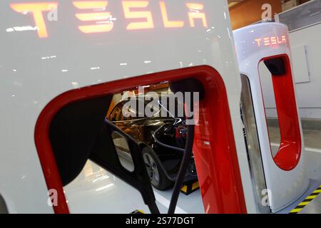 Bangkok, Thailand - 17. Februar 2023: Das Elektroauto Tesla wird an der brandneuen Tesla EV-Kompressorstation im Centralworld Shopping aufgeladen. Stockfoto