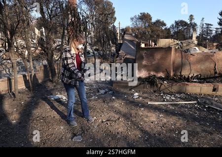 Altadena, Kalifornien, USA. Januar 2025. Lauryn Sayler Divers hält einen verkohlten Baseballschläger in ihrem Haus, das durch den Eaton-Brand in Altadena, Kalifornien, zerstört wurde. Mindestens 27 Menschen sind gestorben, und Tausende von Gebäuden sind bei den Bränden Eaton und Palisades verbrannt. (Credit Image: © Jonathan Alcorn/ZUMA Press Wire) NUR REDAKTIONELLE VERWENDUNG! Nicht für kommerzielle ZWECKE! Stockfoto