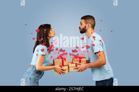 Ein Paar teilt sich einen liebevollen Kuss mit Geschenken zum Valentinstag Stockfoto
