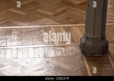 Sockel und Sockel einer Säule in einem klassischen Innenraum mit Holzparkett auf dem Boden Stockfoto