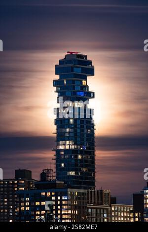 Beeindruckender nächtlicher Blick auf den Jenga Tower an der Leonard Street 56 in New York City, mit seinem markanten, gestapelten Design, beleuchtet gegen ein leuchtendes, c Stockfoto
