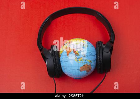 Headset auf Globus isoliert auf dem roten Stockfoto