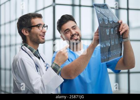 Zwei weiße Ärzte betrachten das mrt-Bild und diskutieren darüber. Schließen. Stockfoto