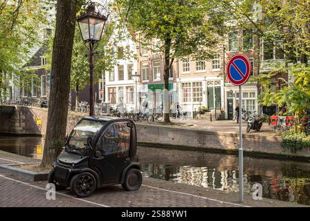 Sehr kleines Auto - Biro Urban, parkt am Kanal im Zentrum von Amsterdam. Stockfoto